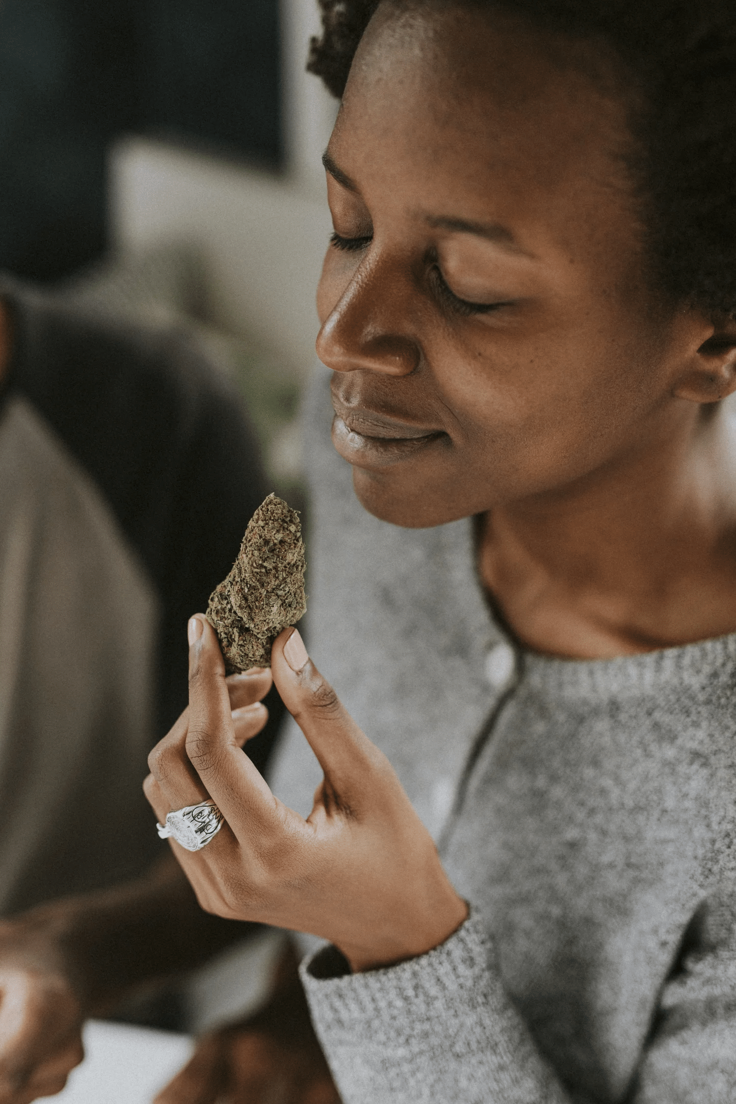 Woman holding cannabis nugget in her hand